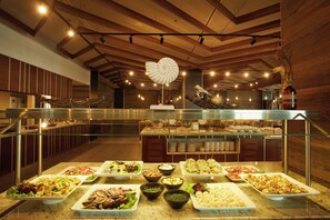 A buffet with various dishes, a hanging sculpture, and a glass railing. - Secrets Sunny Beach Resort & Spa (Nessebar)