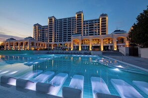 A hotel with a large swimming pool, multiple balconies, and a modern architectural design. - Secrets Sunny Beach Resort & Spa (Nessebar)
