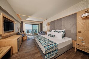 A modern hotel room with a large bed, a TV, a desk, and a balcony with a city view. - Secrets Sunny Beach Resort & Spa (Nessebar)