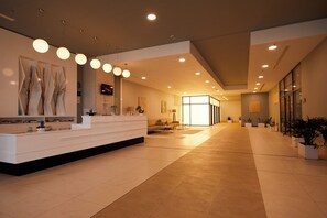 A spacious lobby with a reception desk, seating area, and potted plants. - Secrets Sunny Beach Resort & Spa (Nessebar)