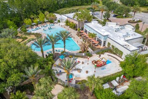 An aerial view of a resort with a large pool, palm trees, and a building with a flat roof. - Palm Luxe at Captiva •Heated pool•BBQ• (Davenport)