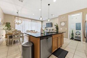 A modern kitchen with a central island, stainless steel dishwasher, and pendant lighting. - Palm Luxe at Captiva •Heated pool•BBQ• (Davenport)