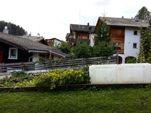 A residential area with houses, a garden, and a white structure. - Schweizer, Obersaxen-Affeier, (Obersaxen), 34006B by Interhome (Obersaxen Affeier)