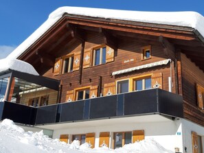 A wooden chalet with a balcony, snow-covered roof, and a sign reading 'Crescioli-Ris'. - Schweizer, Obersaxen-Affeier, (Obersaxen), 34006B by Interhome (Obersaxen Affeier)