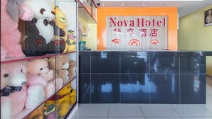 A reception area with a glass display of plush toys and a sign for Nova Hotel. - Nova Hotel Ipoh by Zuzu (Ipoh)