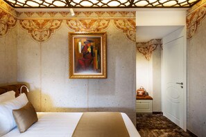 A hotel room with a bed, a painting on the wall, and a door leading to another room. - Gallery 37, BW Premier Collection (Plovdiv)