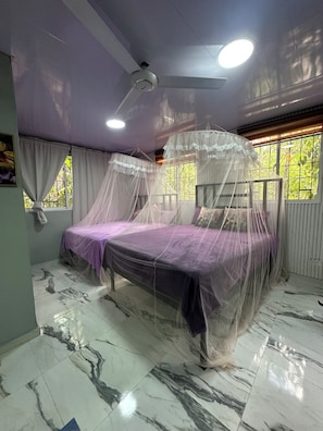 A bedroom with a bed covered in a canopy, a ceiling fan, and a window with curtains. - 6/separate villa/picina /Jacuzzy and more (Paya)