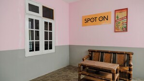 A room with a window, a wooden bench, and a wall with a sign that reads 'SPOT ON.' - Spot On 2046 Villa Hardi (Batu)