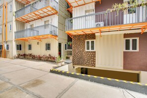 A multi-story building with balconies, a courtyard, and a mix of building facades. - OYO 3300 Nadjara Residence (Jakarta)