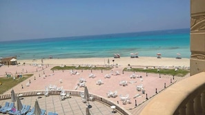 A beachside hotel with outdoor seating areas, a pool, and a view of the ocean. - Royal Sea View (Alexandria)