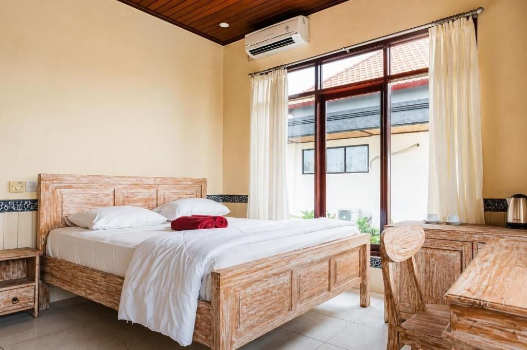 Una camera da letto con un letto di legno, una scrivania e una sedia.