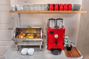 A buffet setup with food containers, a coffee machine, and serving utensils. - Taksim Terrapia Hotel (Istanbul)