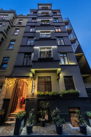 A multi-story building with a modern facade, balconies, and potted plants. - Taksim Terrapia Hotel (Istanbul)