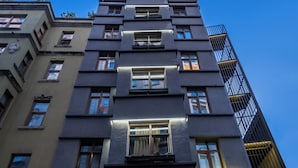 A multi-story building with a modern facade, balconies, and potted plants. - Taksim Terrapia Hotel (Istanbul)