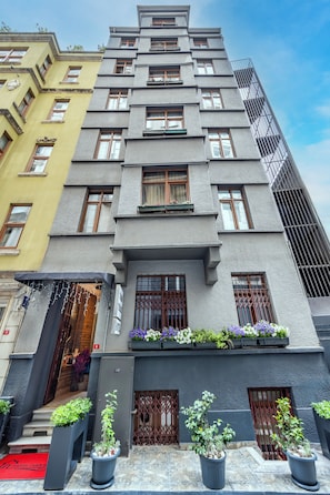 A multi-story hotel with a modern facade, large windows, and a red carpet at the entrance. - Taksim Terrapia Hotel (Istanbul)