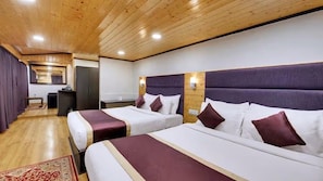 A hotel room with two beds, wooden ceiling, and a small desk with a chair. - Sumitel Sanderling, Darjeeling (Darjeeling)