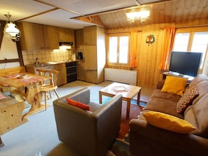 A cozy living room with a sofa, a coffee table, and a television. - Fontauna Degonda, (Sedrun), 235.01 by Interhome (Sedrun)