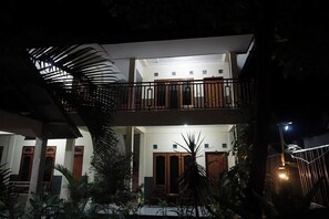 A two-story building with a balcony, wooden doors, and a staircase. - Sagita Bungalow by Zuzu (Gili Trawangan)