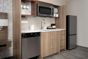 A modern kitchen with a dishwasher, a microwave, a coffee maker, and a refrigerator. - Home2suites by Hilton Miami Airport S. Blue Lagoon (Miami)