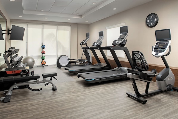 A gym with treadmills, a weight bench, and exercise balls. - Home2suites by Hilton Miami Airport S. Blue Lagoon (Miami)