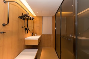 A modern bathroom with a wooden vanity, a glass shower enclosure, and a towel rack. - Ji Hotel (hangzhou South Railway Station, Xiaoshao (Hangzhou)