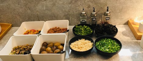 A kitchen counter with various food ingredients and condiments.