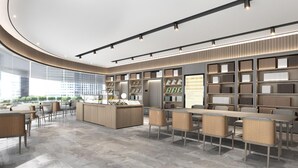 Una biblioteca moderna con estanterías, un mostrador de recepción y zonas de estar.