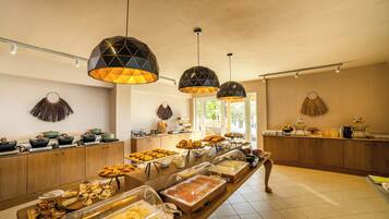 A buffet with various food items and a wooden counter.