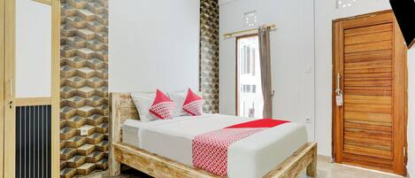Ein Schlafzimmer mit einem hölzernen Bettgestell, einem Kleiderschrank und einer Wand mit Muster.