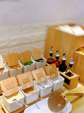 A kitchen counter with various food containers and utensils.