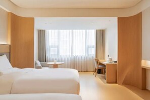 A hotel room with two beds, a desk, and a chair. - Ji Hotel (Tianjin)