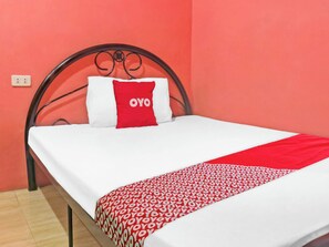 A bed with a white mattress, a red and white pillow, and a red and white patterned blanket. - Vaccinated Staff - 868 Solanos Transient House (Pasay)