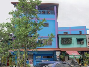 A multi-story building with a blue and purple facade, featuring balconies and air conditioning units. - Vaccinated Staff - 868 Solanos Transient House (Pasay)