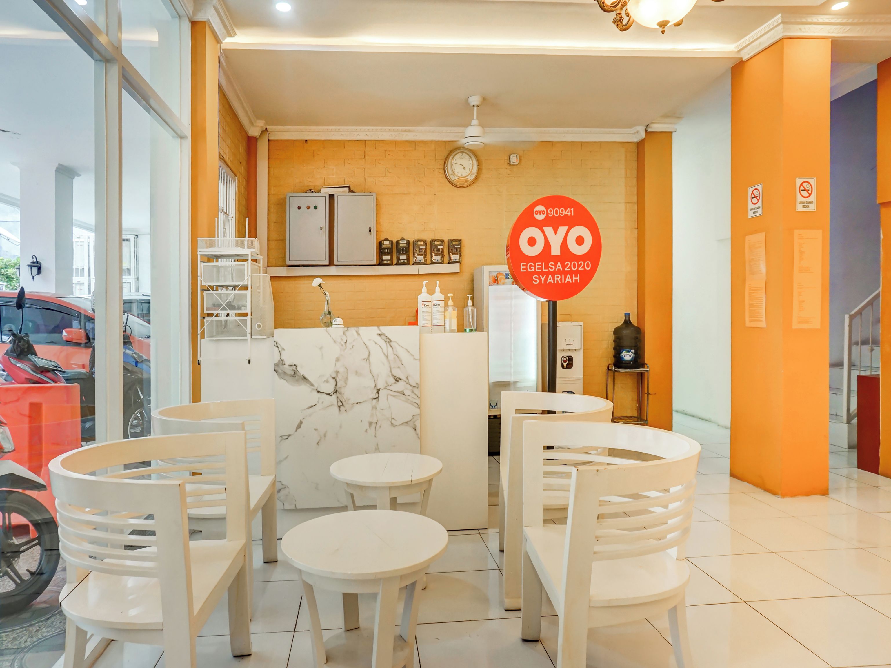 A clean, modern interior with marble countertops, white chairs, and a central island.