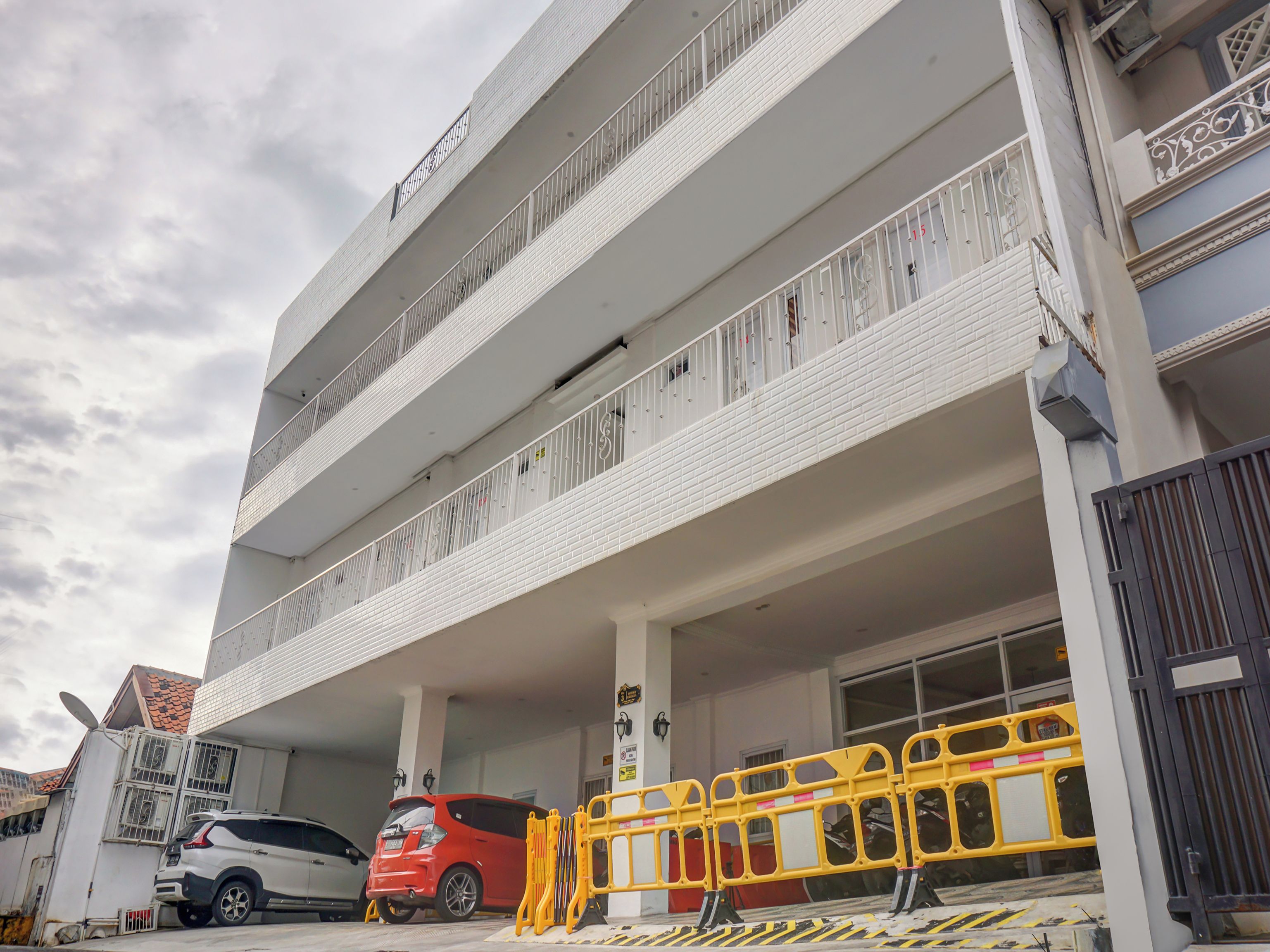 A multi-story building with a parking garage.