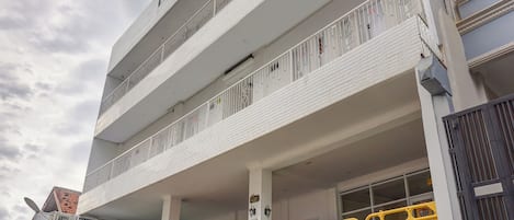A multi-story building with a parking garage.