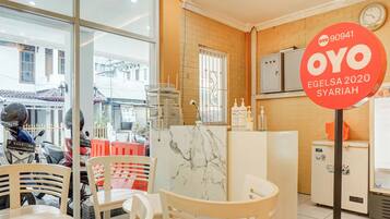 A cafe with a marble counter, wooden chairs, and a sign indicating a special offer.
