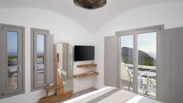 A modern bedroom with a TV, wooden bench, and a balcony with a table and chairs.