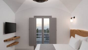 A bedroom with a bed, a TV, wooden shelves, a balcony door, and a wall-mounted light fixture.