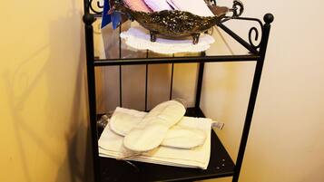 A corner shelf with folded towels and a decorative item.