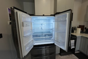 A modern kitchen with a built-in refrigerator, oven, and a stainless steel sink. - Escape to Muniz Village Unit C (Three Rivers)