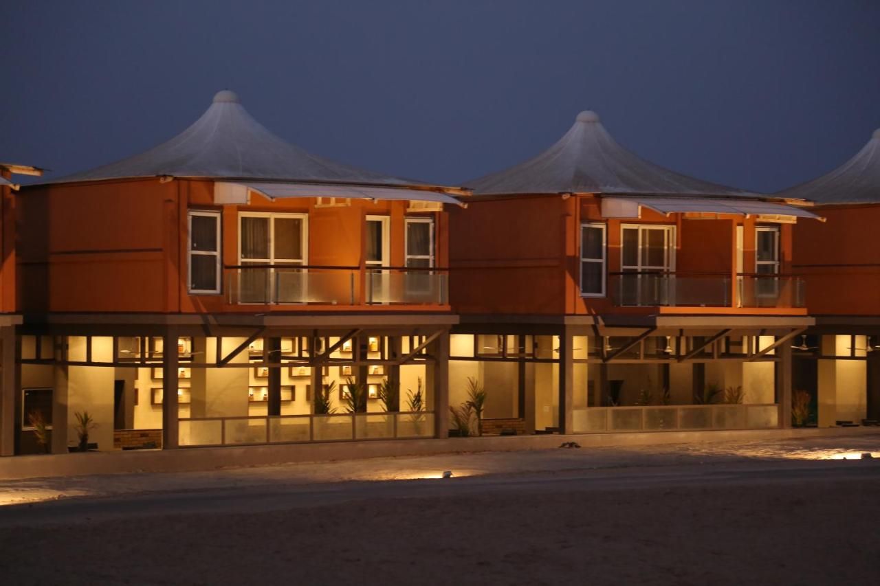 A hotel with a modern design, featuring a flat roof and large windows.