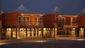 A hotel with a modern design, featuring a flat roof and large windows.