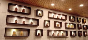 A wall with multiple shelves displaying various items. - The Fern Leo Beach Resort (Porbandar)