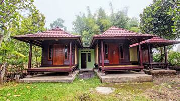 A wooden structure with a central door and two smaller rooms on either side.
