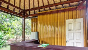 A wooden reception desk with a door to the right. - Oyo 91830 Hotel Gemilang 2 (Sembalun Lawang)