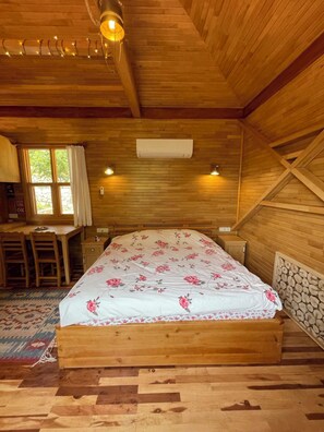 A wooden room with a bed, a desk, and a window. - Trinitys Forest Bungalows (Antalya)