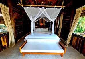 A bed with a canopy in a wooden room with curtains. - Ocean Bay Resort & Spa Phu Quoc (Phu Quoc)