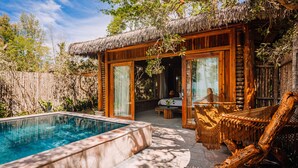 A poolside area with a thatched-roof structure, a hammock, and a view of the interior. - Ocean Bay Resort & Spa Phu Quoc (Phu Quoc)