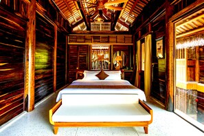 A wooden cabin interior with a large bed, wooden walls, and a ceiling fan. - Ocean Bay Resort & Spa Phu Quoc (Phu Quoc)